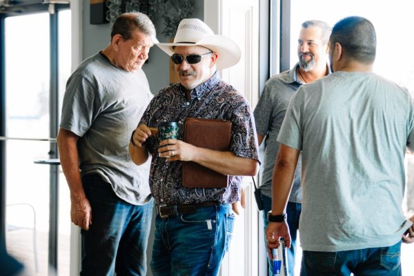 Men arriving in jeans, boots and a cowboy hat at Transformation Church in Seminole, Texas