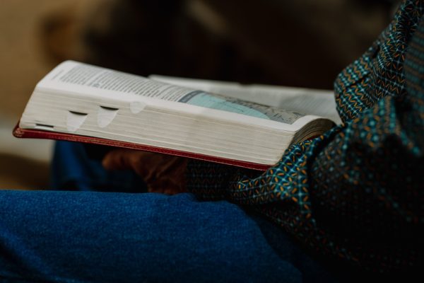 An open Bible on a lap during a service at Transformation Church